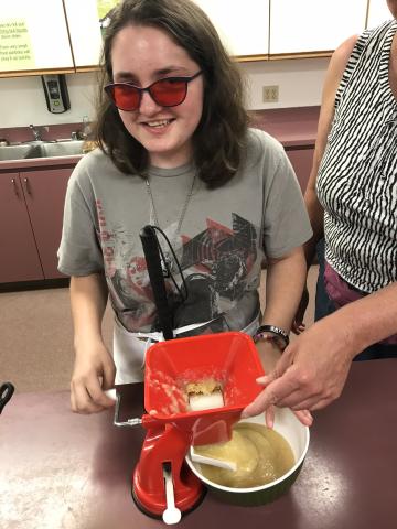 LEAP Participant practices making applesauce for their lunch.