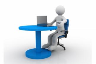 A 3-d figure sitting at a table working on a laptop. Image courtesy of cooldesign on FreeDigitalPhotos.net.