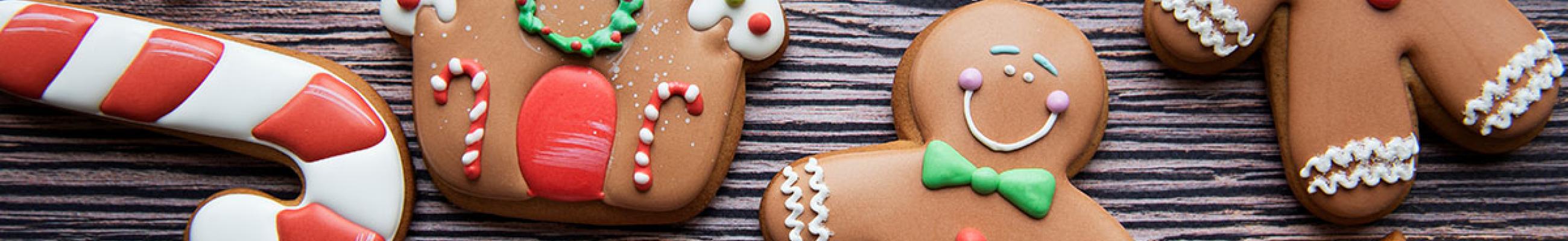 Holiday cookies in the shape of snowflakes, candy canes, and gingerbread people.